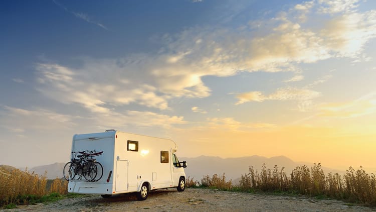 an RV membership programs RV parked on a cliff overlooking a beautiful landscape